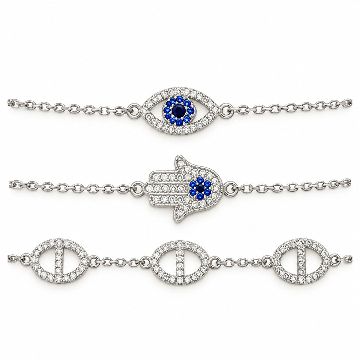 Three silver-tone anti-tarnish chain bracelets featuring a blue evil eye charm, a crystal-studded Hamsa hand centerpiece, and sparkling oval link motifs, arranged in parallel on a clean white background with a premium polished finish.
