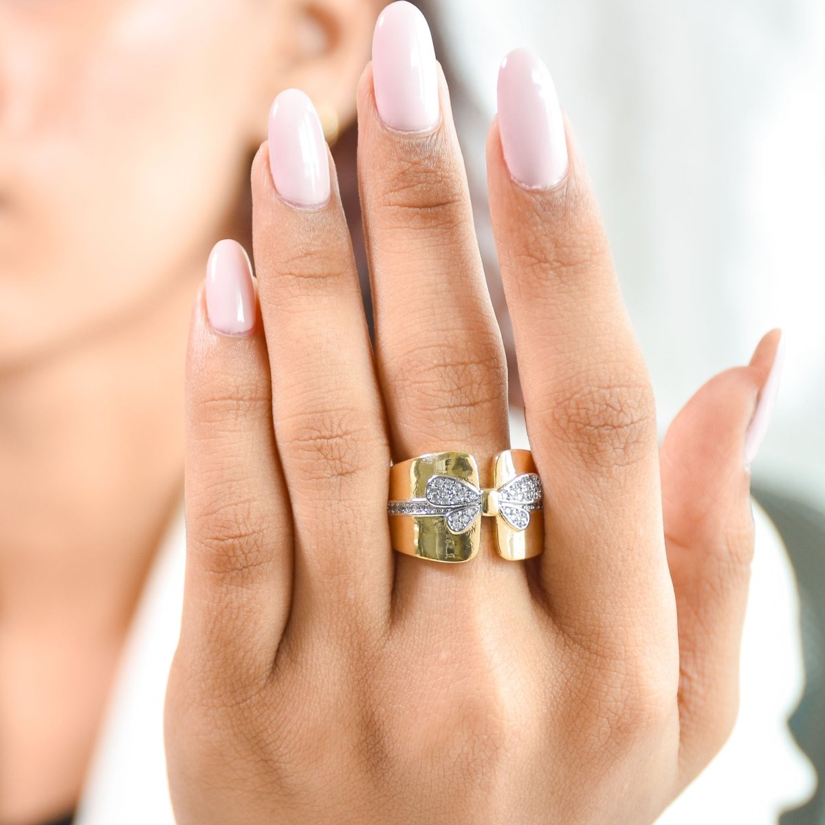 Elegant golden bow ring with sparkling pavé detailing and an anti-tarnish finish. perfect for playful glamour, special occasions, and chic everyday styling.
