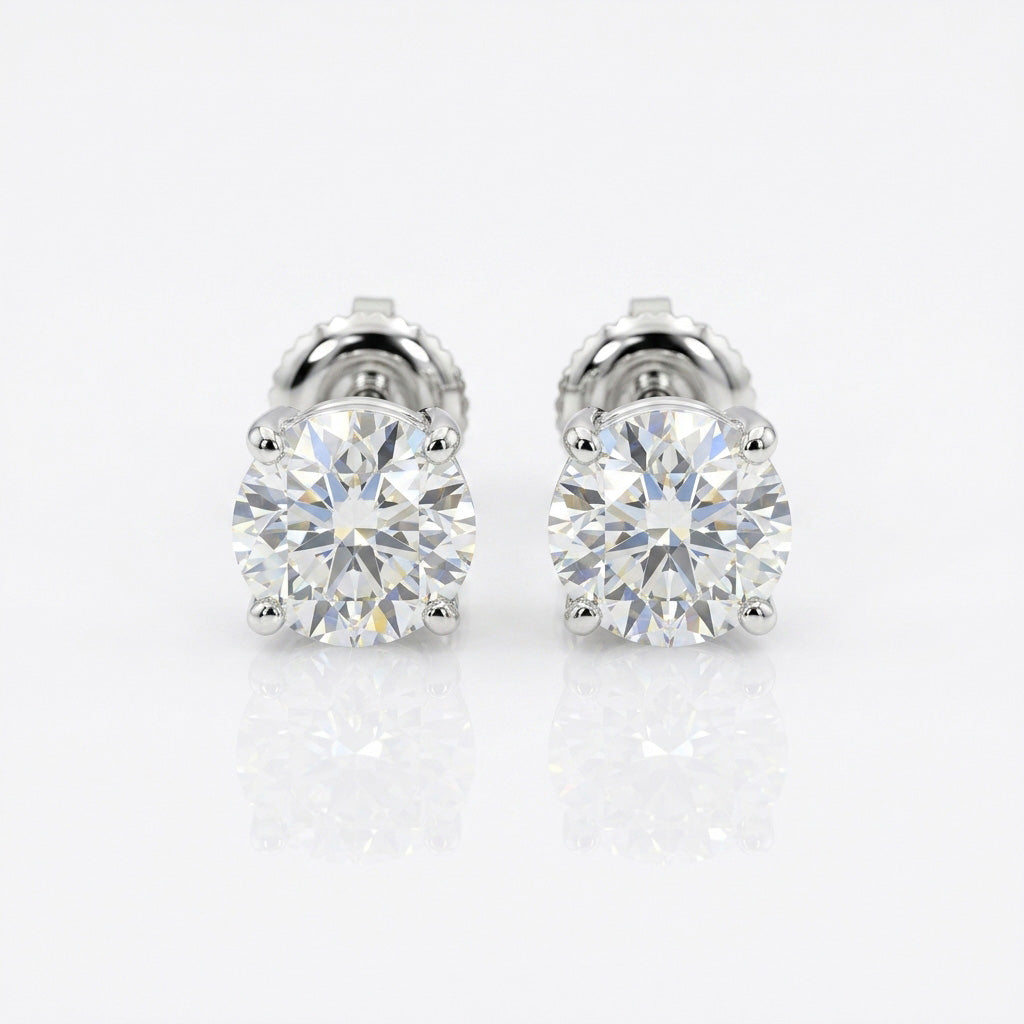 Signature Diamond Studs with brilliant round-cut stones in a classic prong setting for timeless, radiant elegance.