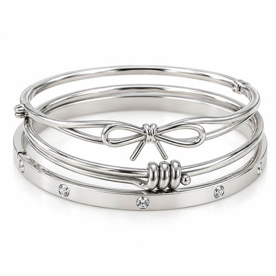 Silver 3-piece bracelet stack featuring a delicate bow bangle, a sleek beaded cuff, and a crystal-studded bangle on a clean white background.