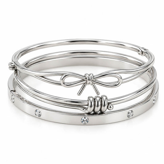 Silver 3-piece bracelet stack featuring a delicate bow bangle, a sleek beaded cuff, and a crystal-studded bangle on a clean white background.
