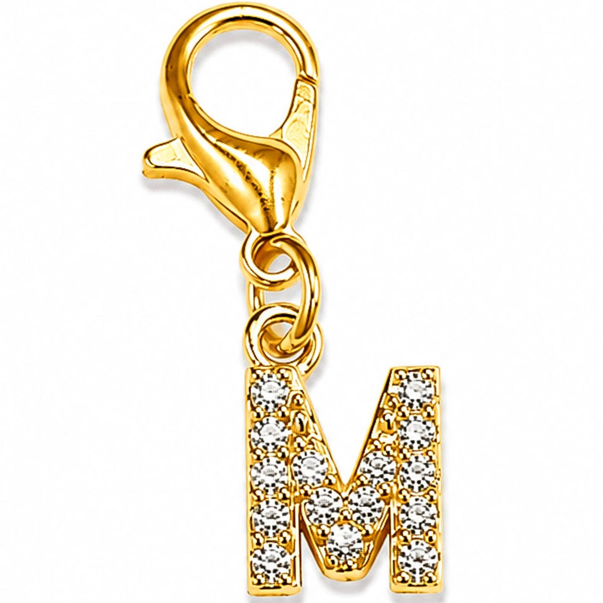 Gold-tone rhinestone-encrusted letter “M” charm with a lobster clasp, displayed on a white background.