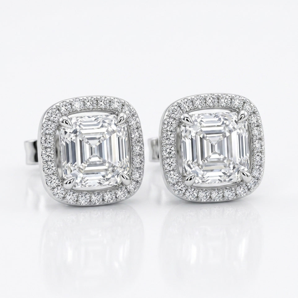 Diamond Frame Studs with precision-cut center stones and shimmering halo frames for bold, timeless elegance.