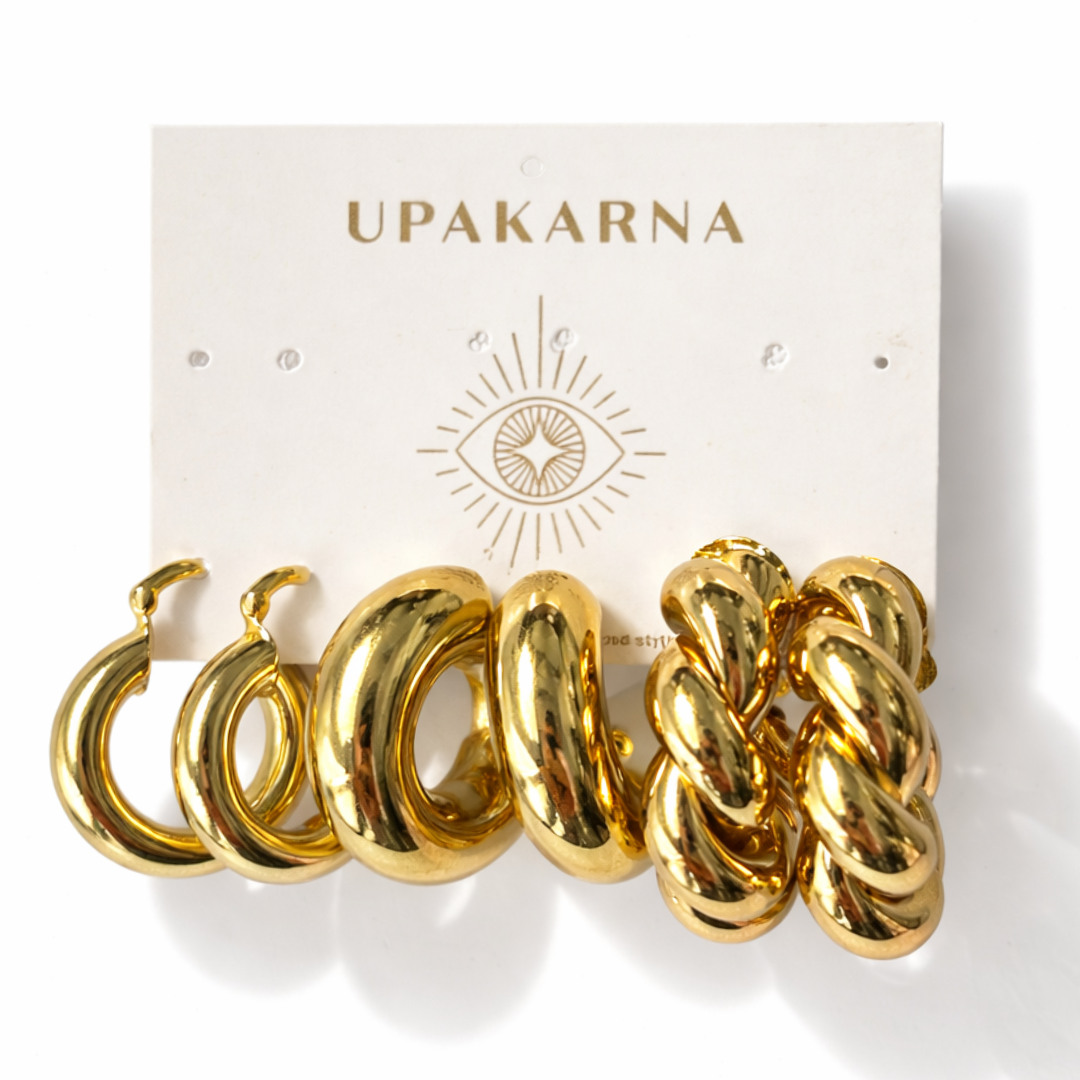 Gold statement hoop earring stack featuring braided hoops, bold cloud hoops, and chunky puffy hoop earrings on a white background.