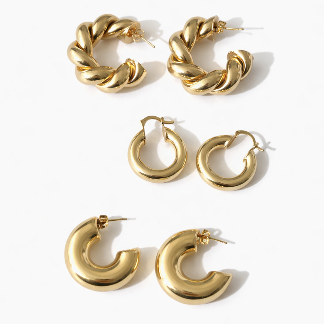 Gold statement hoop earring stack featuring braided hoops, bold cloud hoops, and chunky puffy hoop earrings on a white background.
