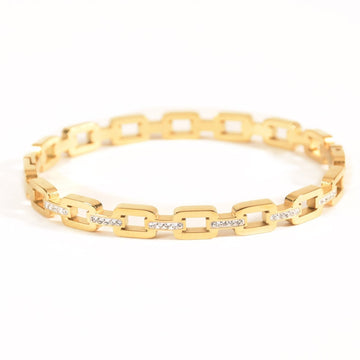 Studded buckle link bangle with sparkling stone detailing and an anti-tarnish finish, available in gold and rose gold, perfect for everyday wear, modern styling, and effortless stacking.
