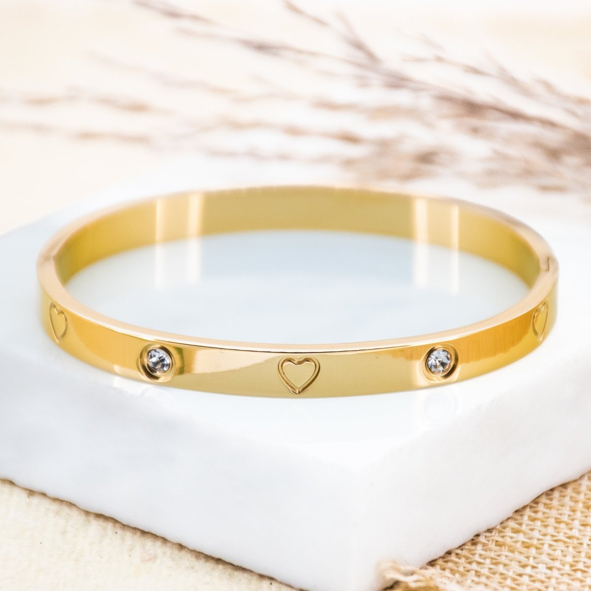 Elegant heart-studded bangles with sparkling detailing and an anti-tarnish finish, available in golden, rosegold, and silver, perfect for everyday wear, gifting, and chic stacked styling.

