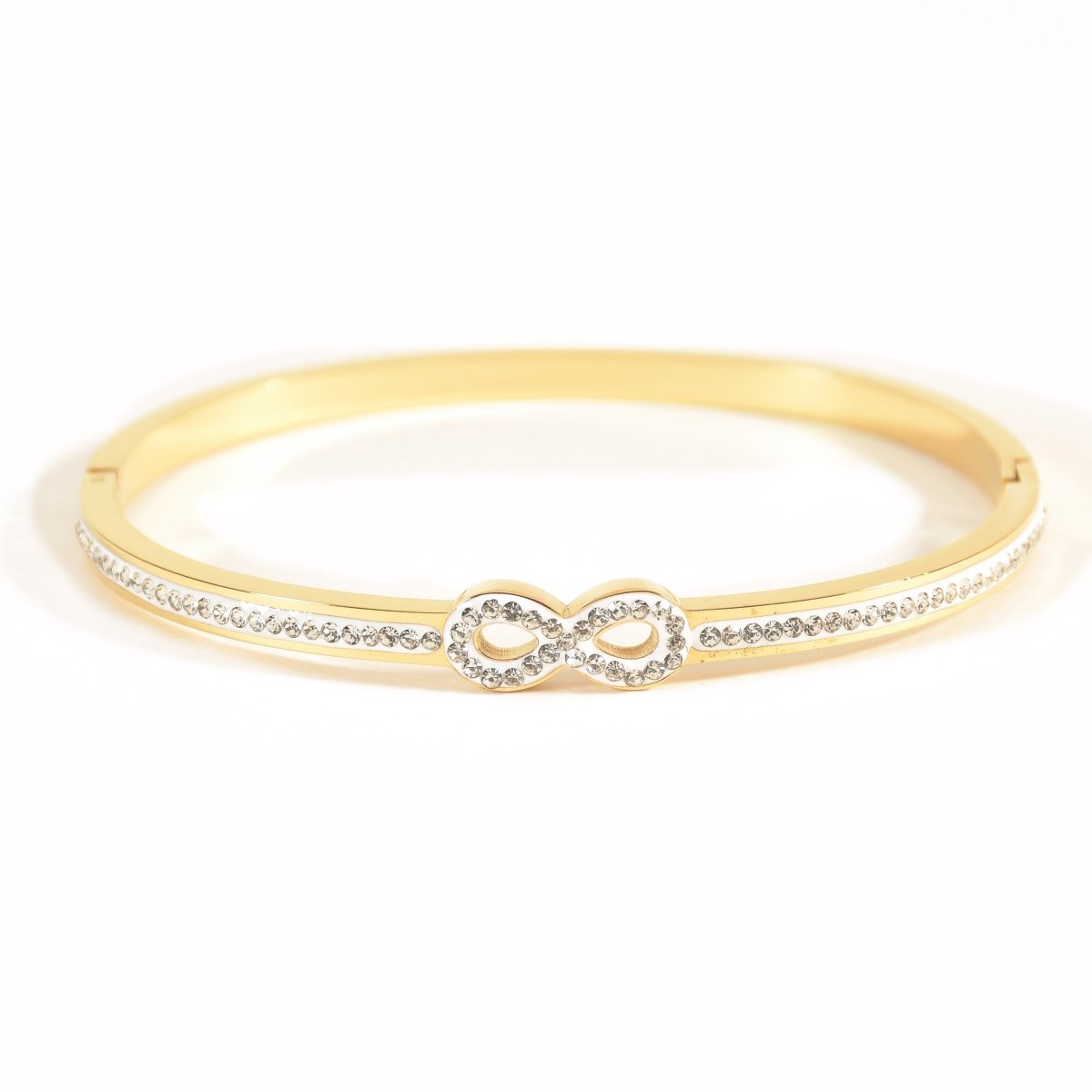 Elegant infinity bangle with sparkling stone detailing and an anti-tarnish finish, available in golden and rosegold, perfect for everyday elegance, gifting, and effortless styling.
