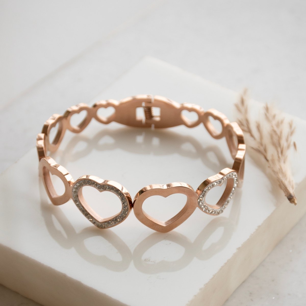 Elegant rosegold heart bangle with sparkling studded detailing and an anti-tarnish finish, perfect for everyday wear, gifting, and romantic chic styling.
