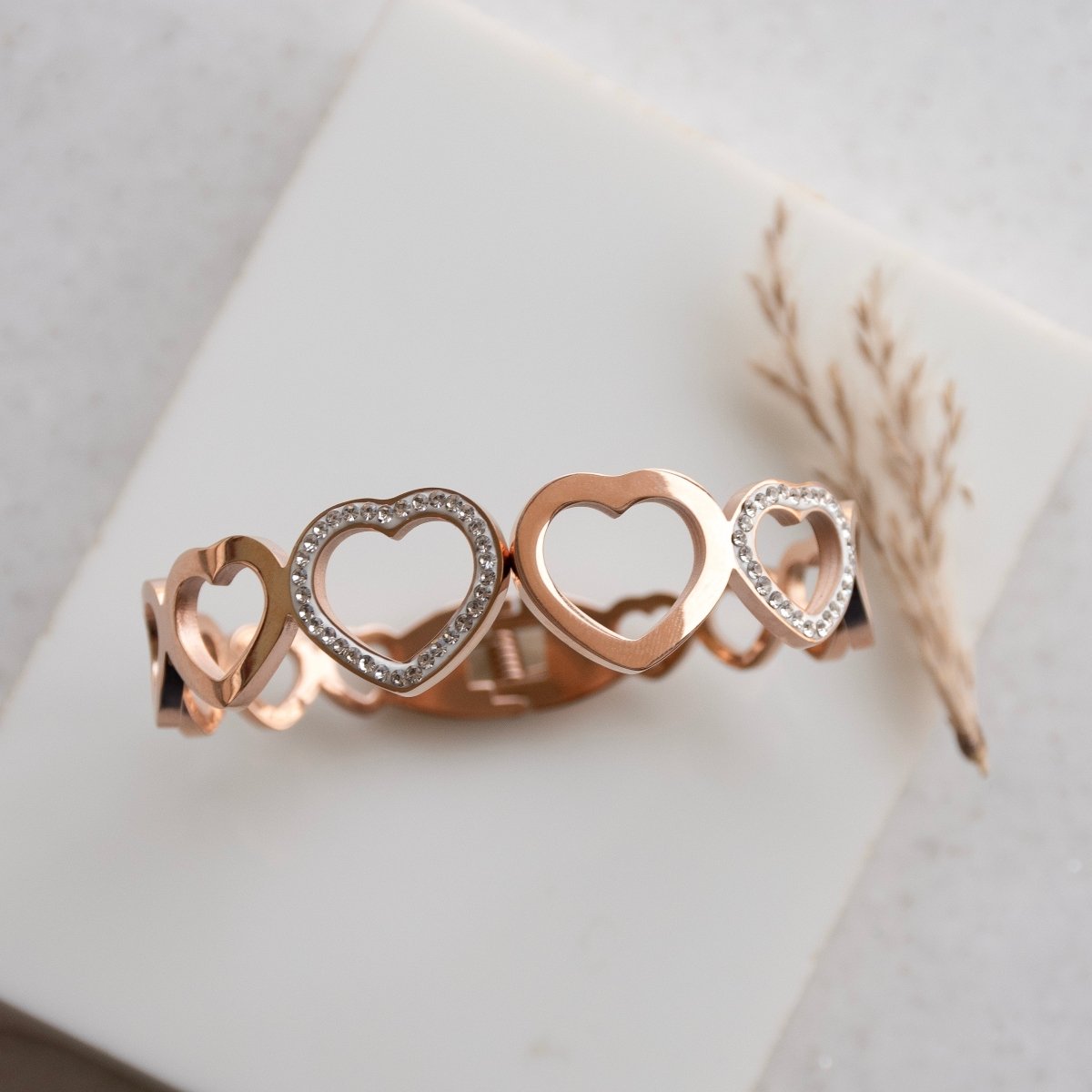 Elegant rosegold heart bangle with sparkling studded detailing and an anti-tarnish finish, perfect for everyday wear, gifting, and romantic chic styling.
