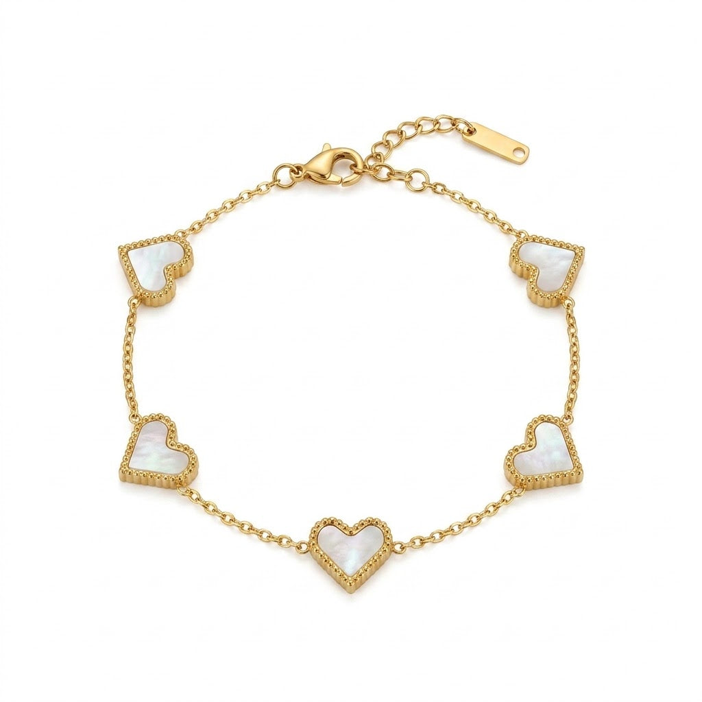 Gold-tone delicate chain bracelet displayed on a clean white background, featuring five heart-shaped mother-of-pearl charms outlined with tiny gold-tone detailing. The bracelet has an adjustable extension chain and lobster clasp for a comfortable fit.