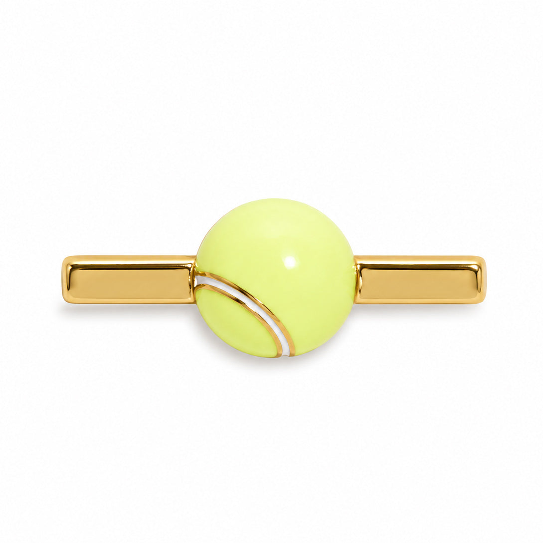 Gold-tone watch accessory featuring a glossy light-yellow tennis ball design on a white background.
