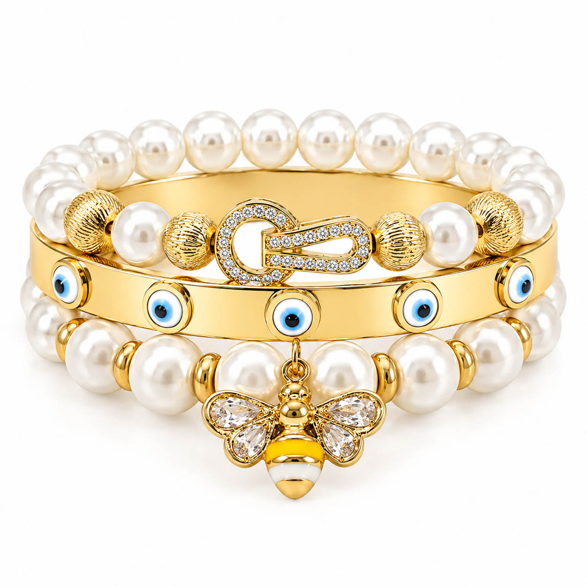A stack of three anti-tarnish gold-plated bangles featuring two pearl bead bangles with a crystal bee charm and textured gold beads, paired with a sleek evil eye bangle accented with blue enamel charms, creating a premium everyday jewellery stack on a clean white background.