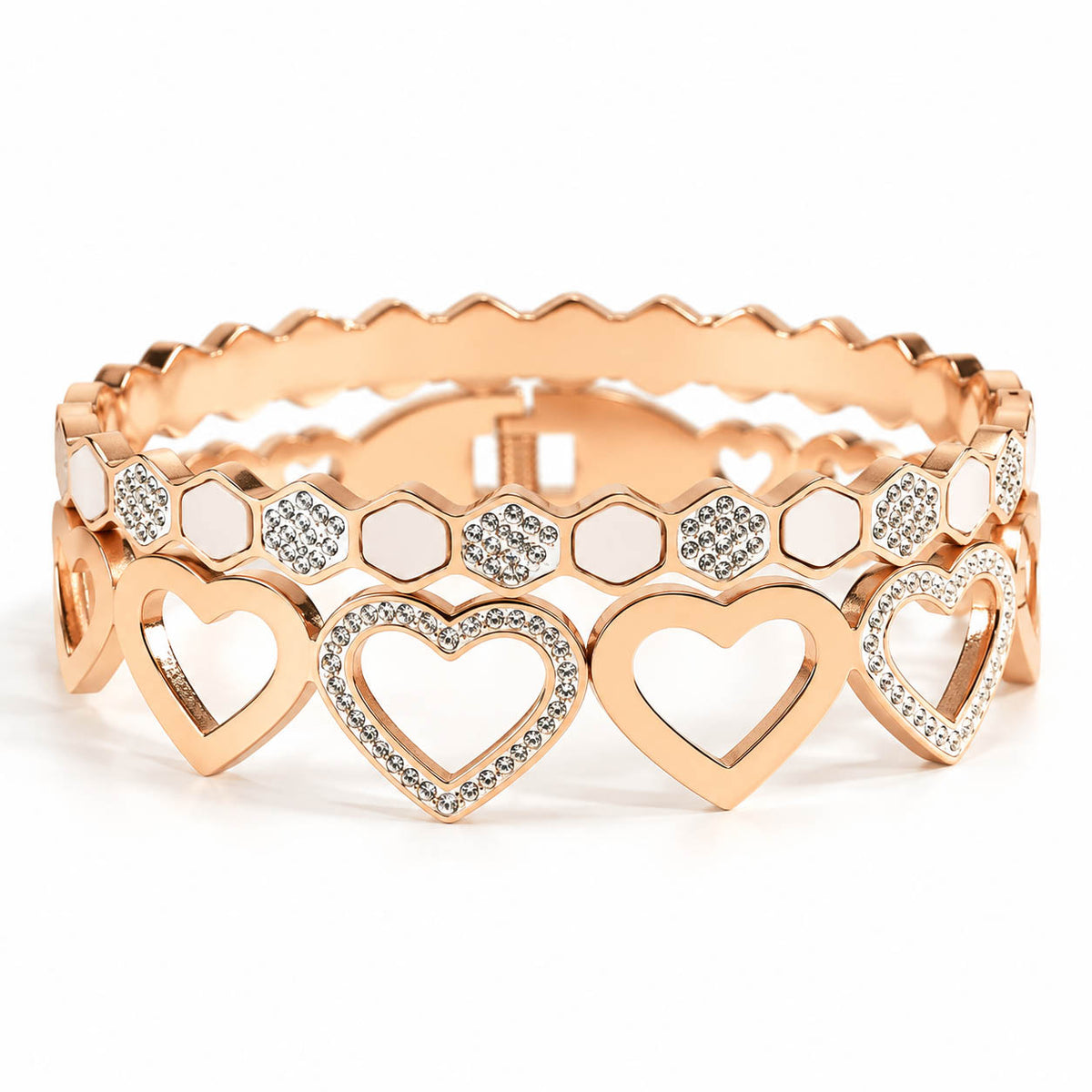 Two rose gold anti-tarnish bangles feature elegant heart motifs, sparkling crystal accents, and white enamel detailing with a secure lock closure, creating a premium romantic stack perfect for everyday wear.