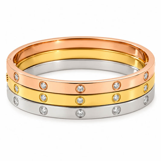 Three anti-tarnish bangles in rose gold, gold, and silver feature sparkling bezel-set crystal accents and a sleek polished finish, creating a timeless everyday stack with a premium minimalist look.