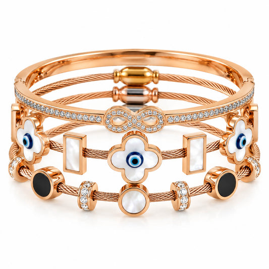 A studio shot of a curated stack of luxury rose gold cable wire bracelets, showcasing an infinity band encrusted with rhinestones, clover-shaped mother-of-pearl stations featuring central evil eyes, and geometric black and white stone inlays.