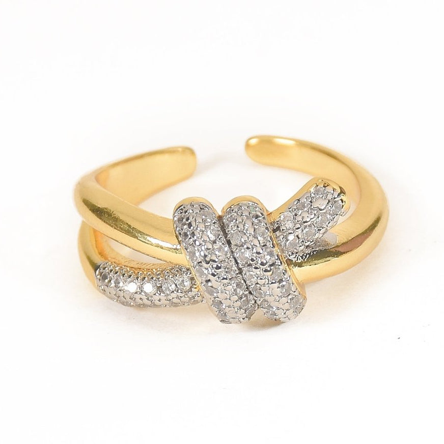 Elegant golden knot ring with sparkling pavé detailing and an adjustable anti-tarnish finish, perfect for everyday elegance, stacking, and timeless styling.
