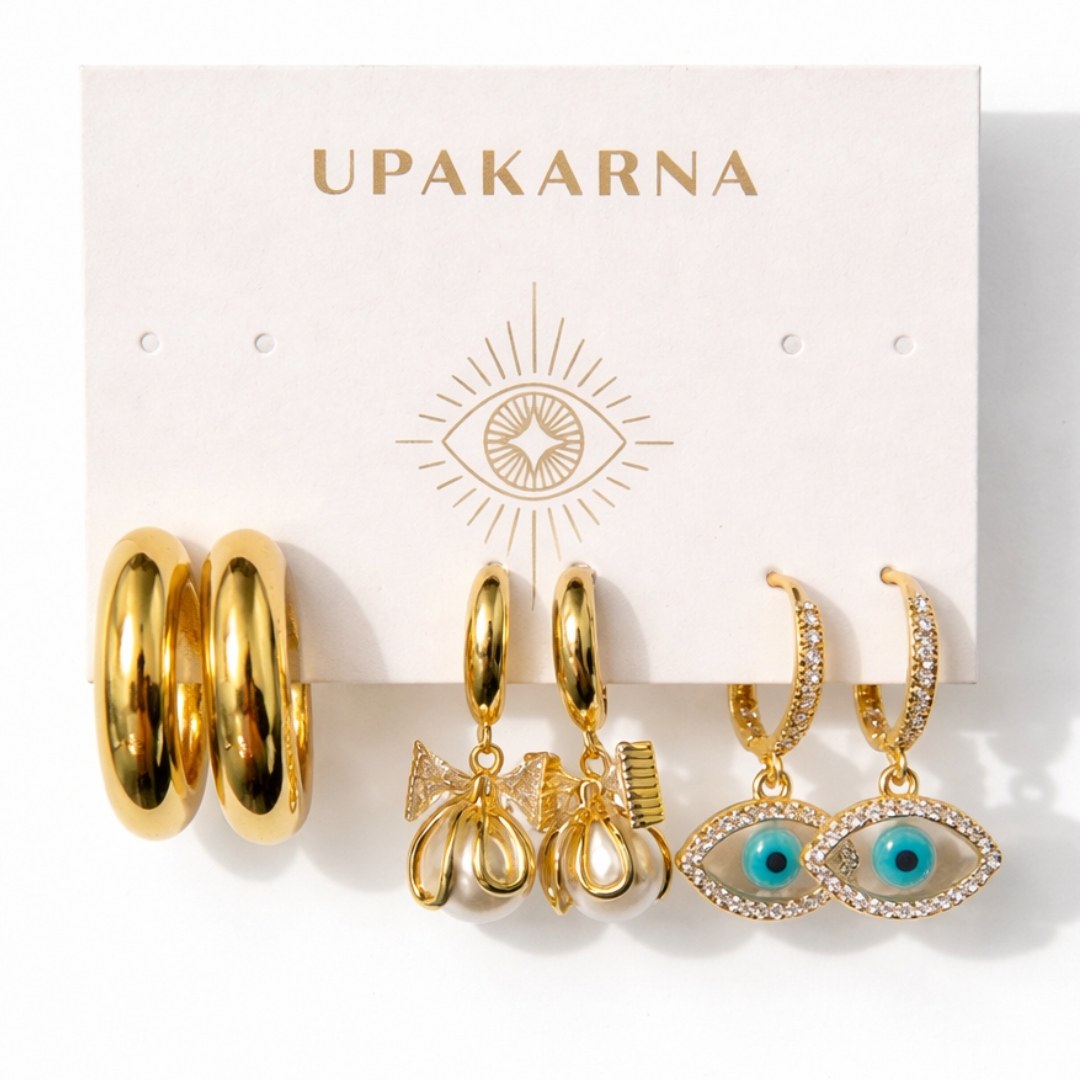 Golden earrings set featuring chunky hoops, pearl bow drop earrings, and evil eye charm drops