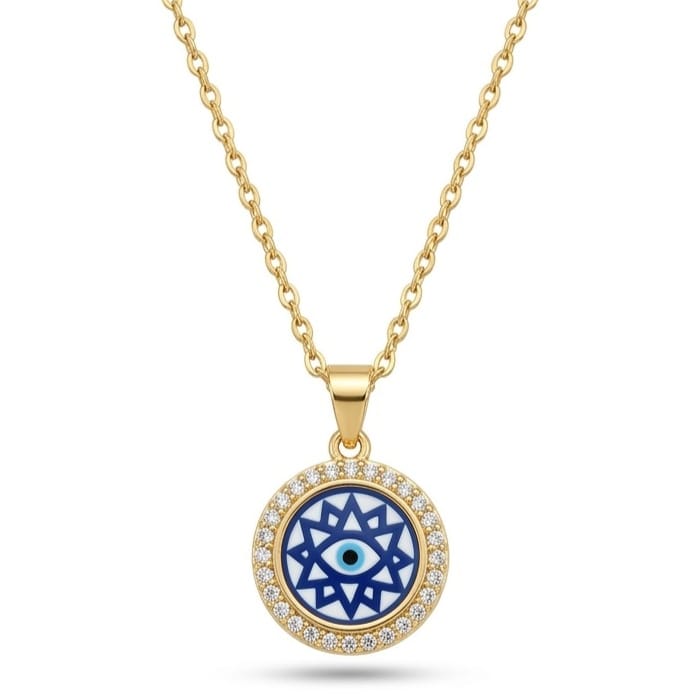 A gold necklace with a circular pendant encrusted with a paved ring of small clear crystals. The center of the pendant showcases a star-like, geometric mosaic pattern in navy blue and white, housing a classic Evil Eye motif. The piece is set against a clean white square background framed by a dark gray border.