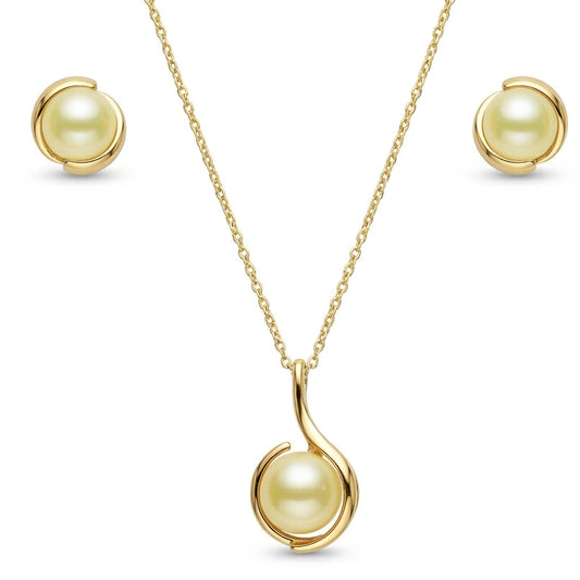 A yellow gold pearl jewelry set isolated on a plain white background, featuring a fine-chain necklace with a pendant that houses a golden pearl cradled within a fluid, swooping curved gold setting. The set is paired with matching stud earrings that feature identical golden pearls wrapped in sleek, complementary gold metal swirls.