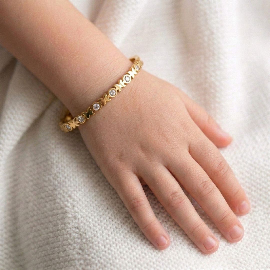 Kids' butterfly bangle with crystal detailing and an anti-tarnish gold finish, perfect for comfortable everyday wear, playful styling, and special occasions.