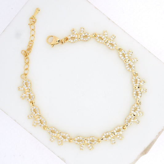 Bow tennis bracelet with sparkling crystal detailing and an anti-tarnish gold-plated finish, perfect for everyday wear, elegant styling, and thoughtful gifting.

