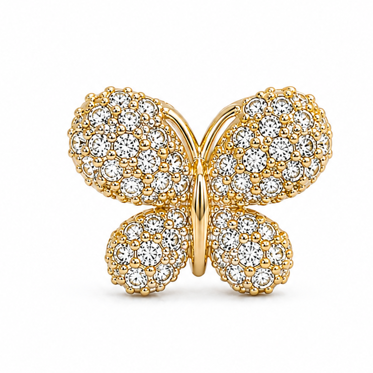 Gold butterfly jewellery charm embellished with multiple clear crystal stones and intricate bead detailing on a white background.