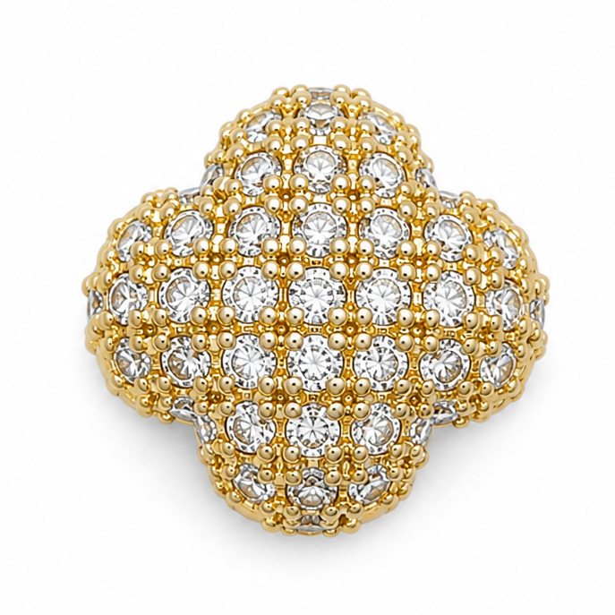 Gold clover-shaped jewellery charm embellished with multiple clear crystal stones and intricate bead detailing on a white background.