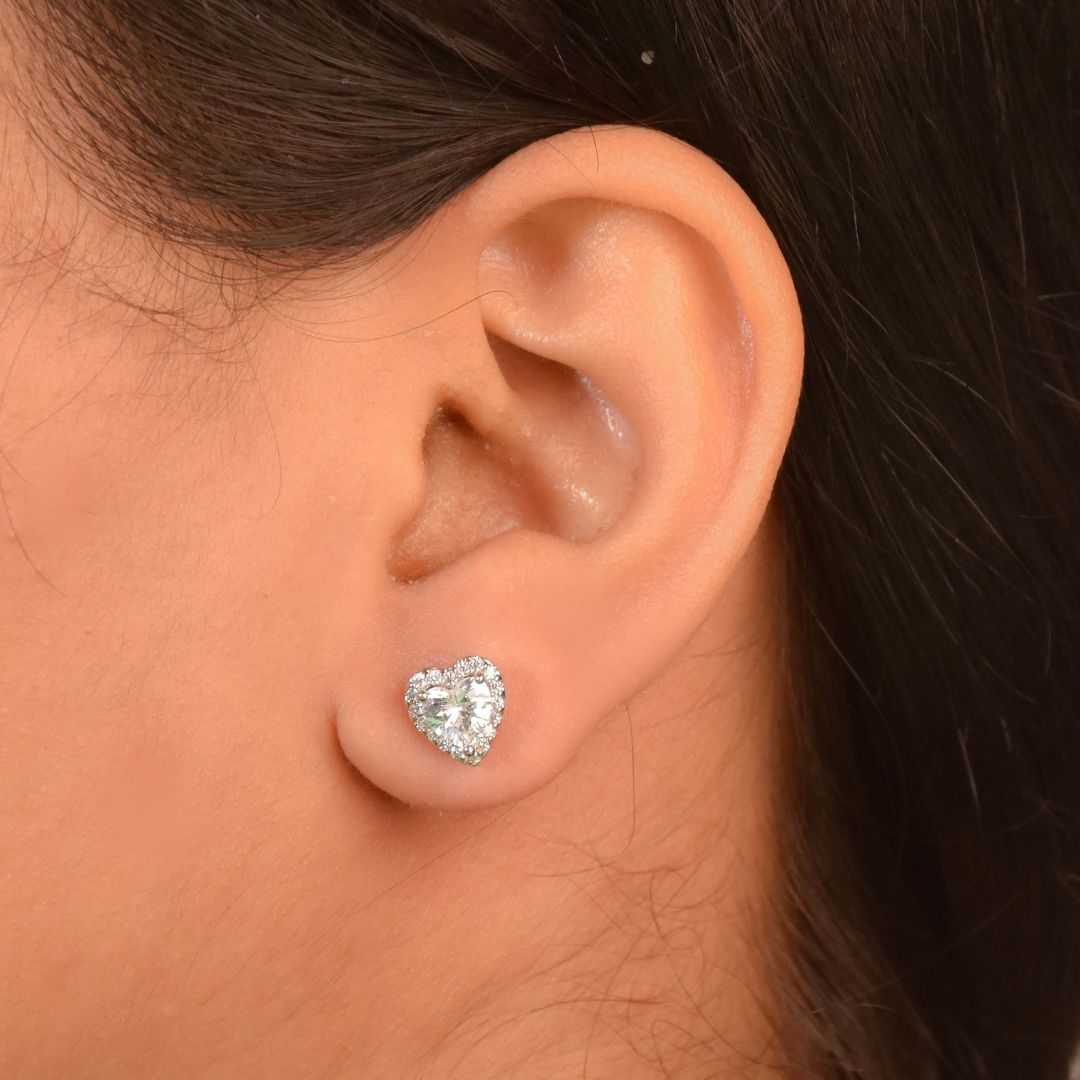 Diamond heart studs with sparkling crystal detailing and an anti-tarnish silver finish, perfect for everyday wear and romantic styling.
