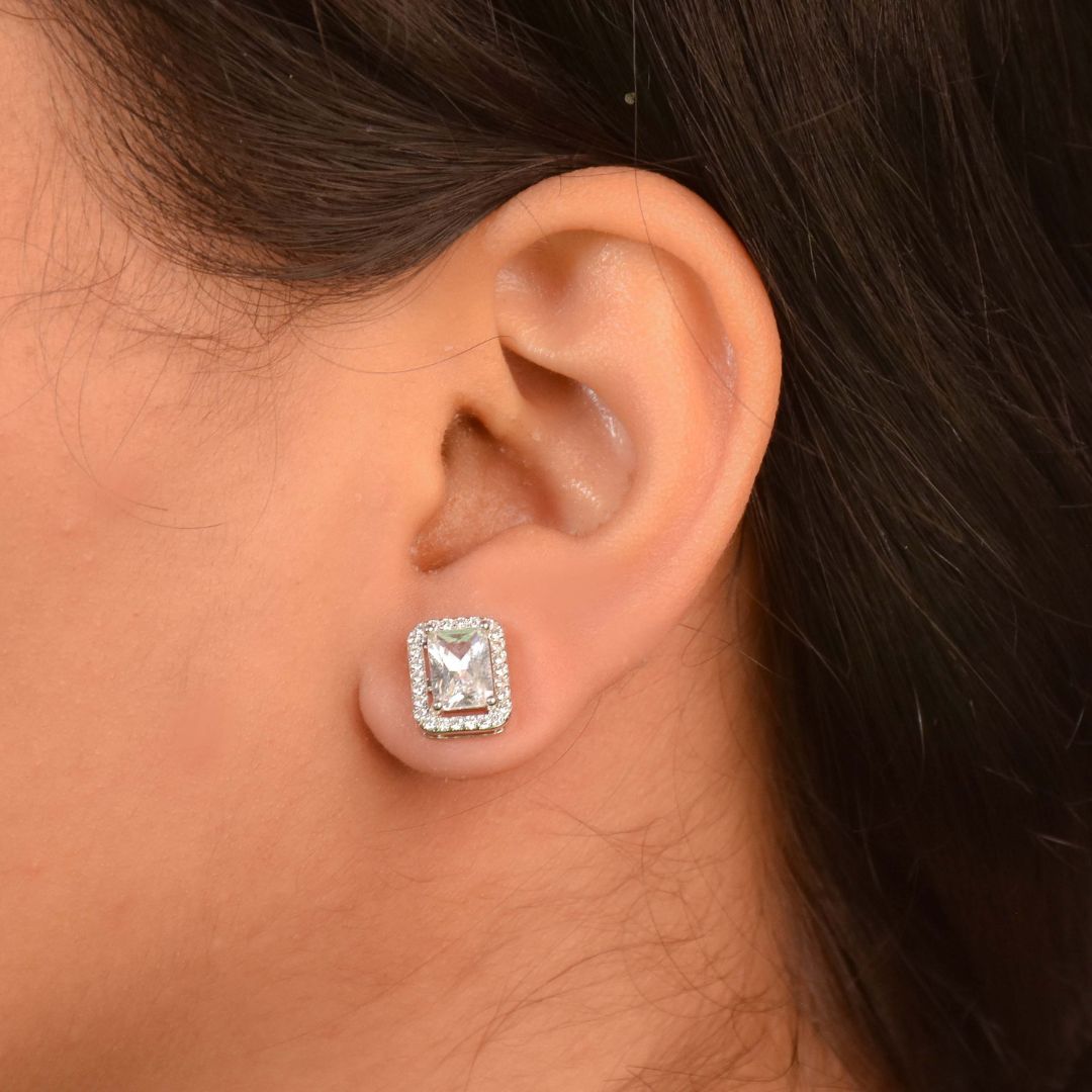 Rectangular halo studs with sparkling crystal detailing and an anti-tarnish silver finish, perfect for everyday wear and elegant styling.

