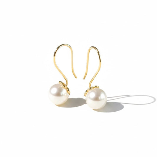 Elegant pearl drop earrings with luminous pearl detailing and an anti-tarnish gold finish, perfect for everyday wear and timeless styling.
