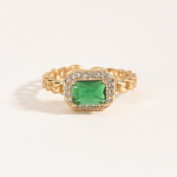 Emerald stone ring with a halo of sparkling crystal accents and an anti-tarnish gold finish, perfect for everyday wear, elegant styling, and statement looks.

