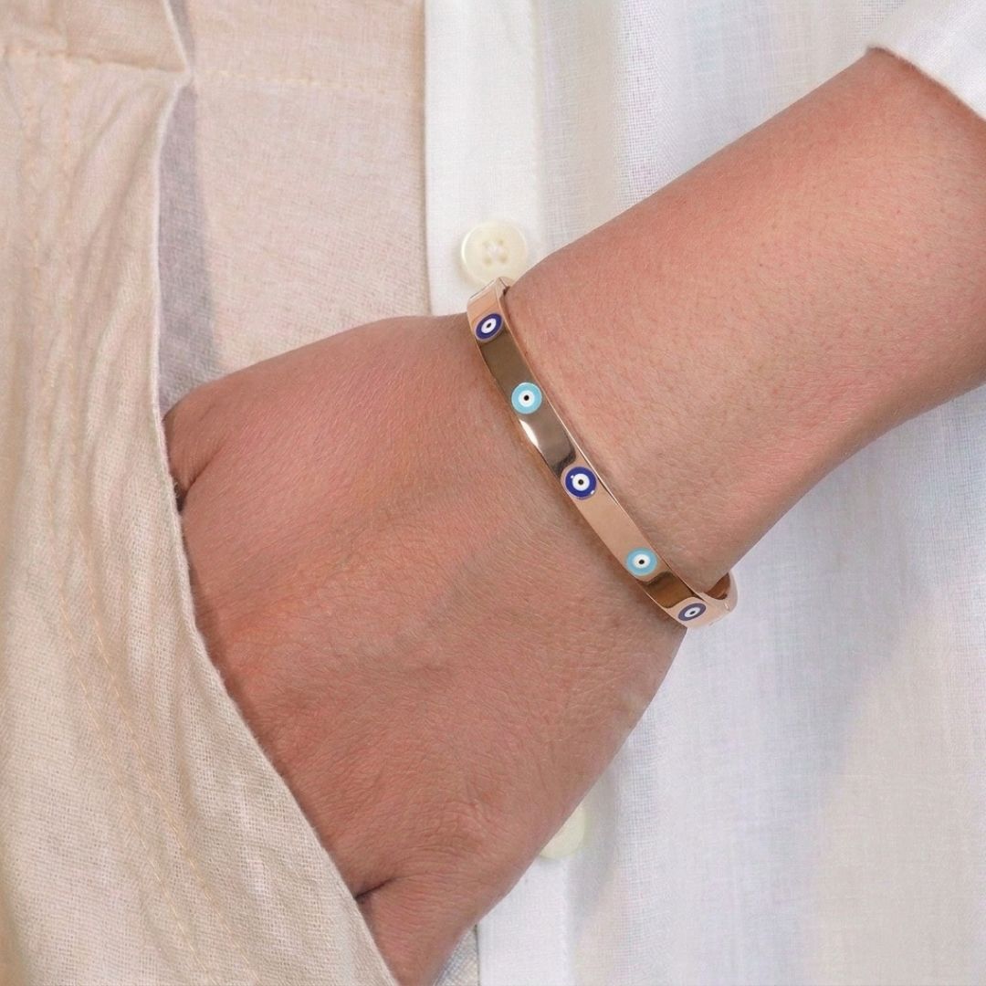 Enamel evil eye bangle with colorful enamel detailing and an anti-tarnish finish, available in gold, rose gold, and silver, perfect for everyday wear, meaningful styling, and effortless stacking.
