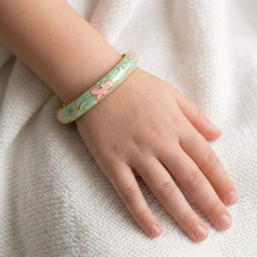 Kids' floral enamel bangle with colorful pastel flower detailing and an anti-tarnish gold finish, perfect for comfortable everyday wear, playful styling, and special occasions.