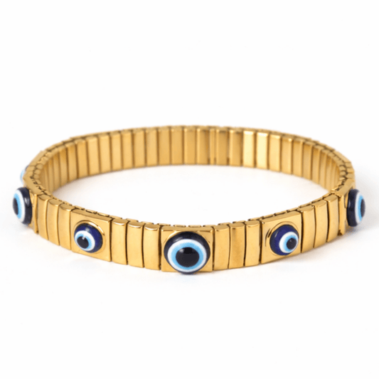 Evil eye bangle with blue enamel detailing and an anti-tarnish finish, available in gold and silver, perfect for everyday wear, meaningful styling, and effortless stacking.