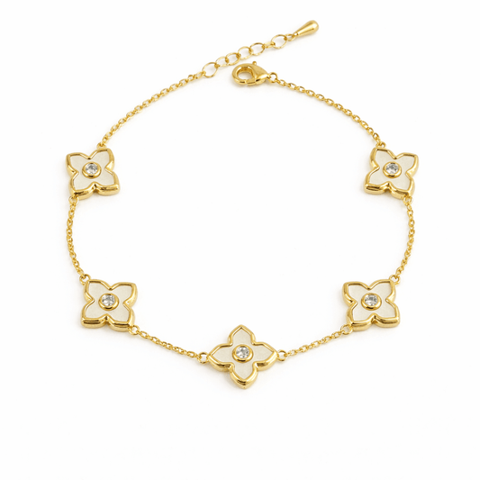 Daisy bracelet with ivory enamel flowers and crystal detailing, finished with an anti-tarnish gold-plated coating, perfect for everyday wear and elegant styling.
