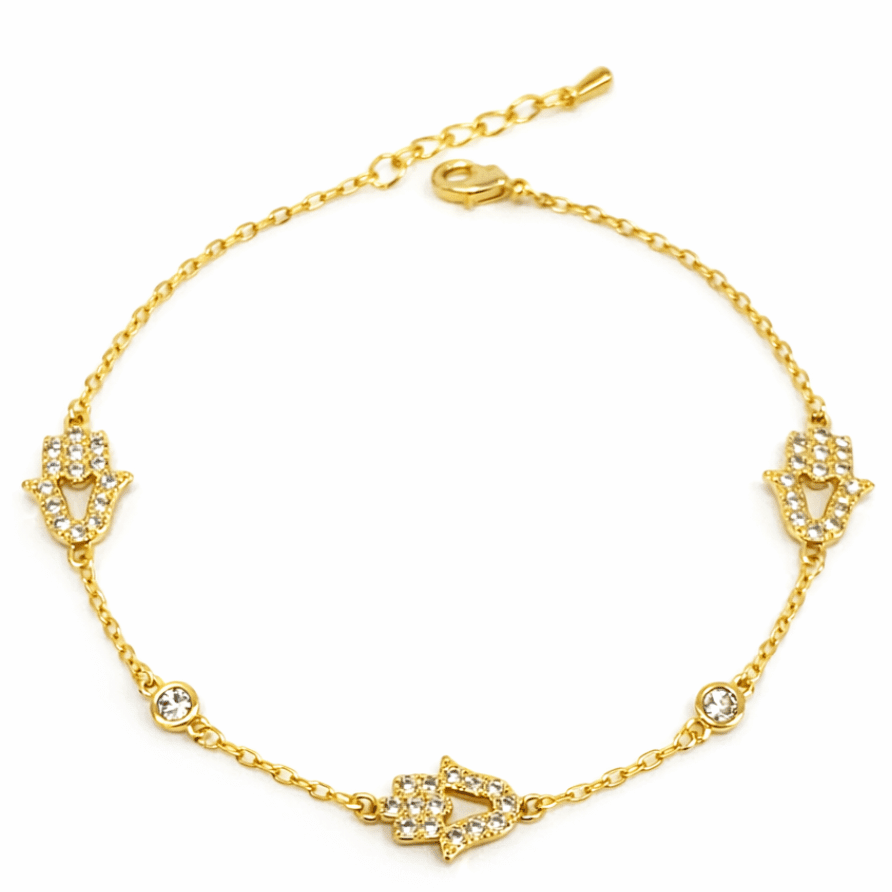 Gold-tone evil eye bracelet featuring sparkling crystal arrow charms and delicate chain detailing.