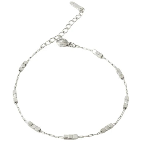The image shows a delicate silver-toned chain bracelet with a fine link chain and several evenly spaced rectangular textured metal accents. It features an adjustable extension chain and a small clasp, photographed on a clean white background.