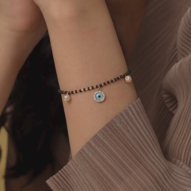 Evil eye mangalsutra bracelet with protective charm detailing and an anti-tarnish gold finish, perfect for everyday wear and meaningful styling.
