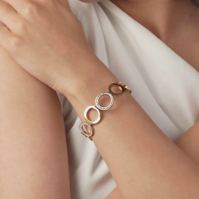 Elegant rosegold multi-ring bangle with sparkling stone detailing and an anti-tarnish finish, perfect for brunch dates, party looks, and chic everyday styling.

