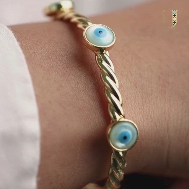 Elegant golden evil eye rope cuff bangle with an adjustable anti-tarnish finish, perfect for trendy everyday styling, chic stacking, and adding a stylish protective touch to any look.