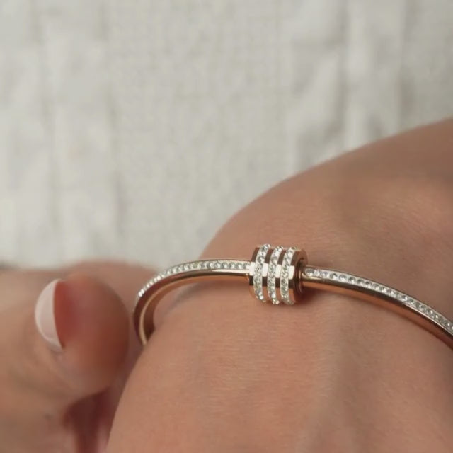 Elegant rosegold twisted sparkle bangle with shimmering stone detailing and an anti-tarnish finish, perfect for everyday glam, casual styling, gifting, and chic layered looks.