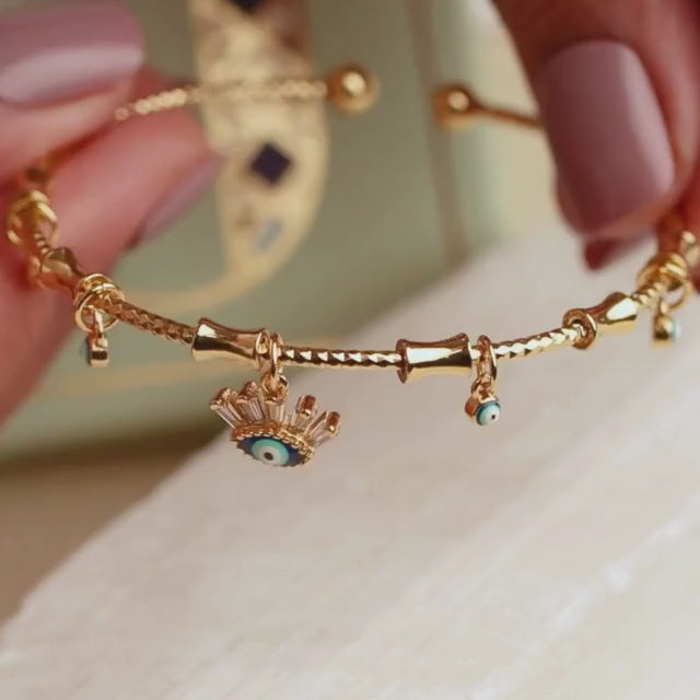Minimal golden charm bangle with a sleek adjustable design and anti-tarnish finish, perfect for everyday wear, dainty styling, and effortless chic looks.
