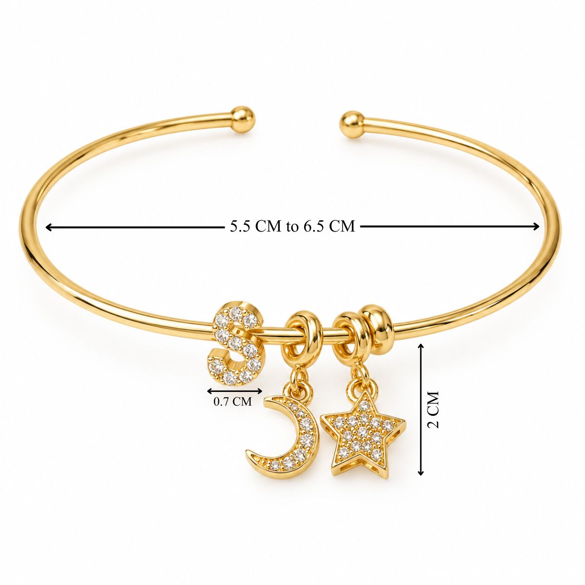 Gold open cuff bangle with a sparkling letter S charm, crescent moon and star charms, shown with size measurements.