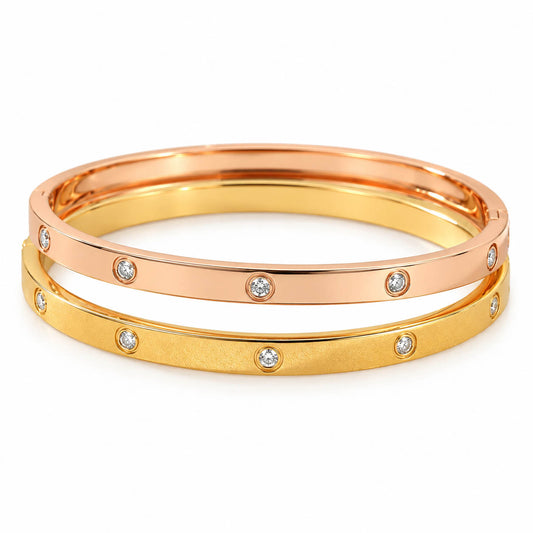 Two-tone crystal bangle set with a polished rose gold and matte gold finish, accented by bezel-set sparkling crystals. Elegant, anti-tarnish, and perfect for everyday wear or stacking.