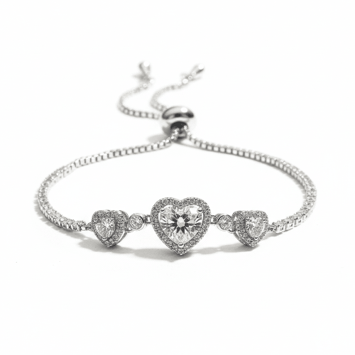 Triple heart tennis bracelet with sparkling heart crystal detailing and an anti-tarnish silver finish, perfect for everyday wear and elegant styling.
