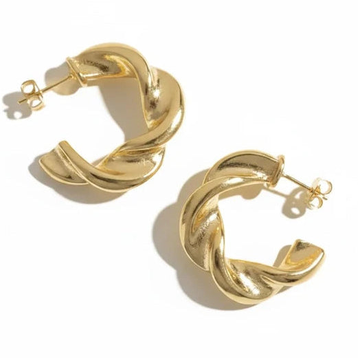Gold-tone twisted hoop earrings featuring overlapping curved bands with a smooth polished finish.