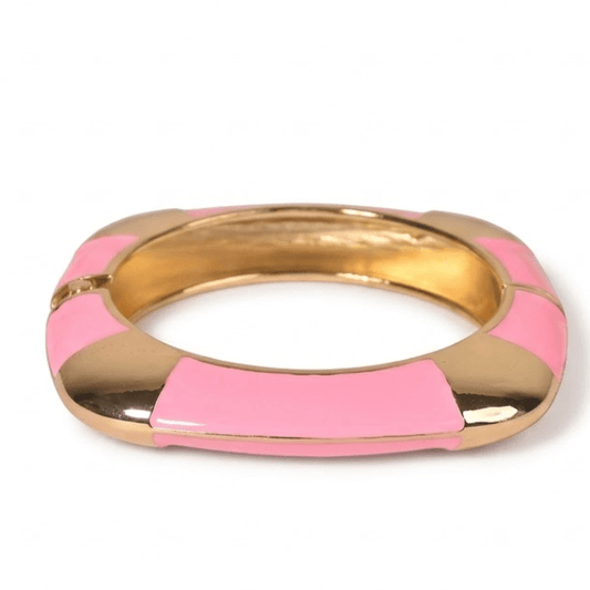 Luxury gold anti-tarnish bangle featuring glossy pink enamel panels, a bold geometric silhouette, and polished stainless steel construction, displayed on a clean white background