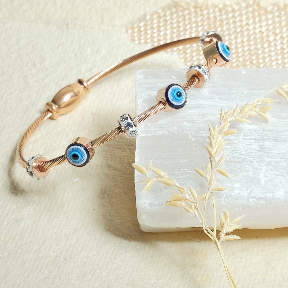 Elegant dainty Evil eye bangle with an anti-tarnish finish, available in rosegold, silver, and golden, perfect for stacking, everyday elegance, and chic versatile styling.
