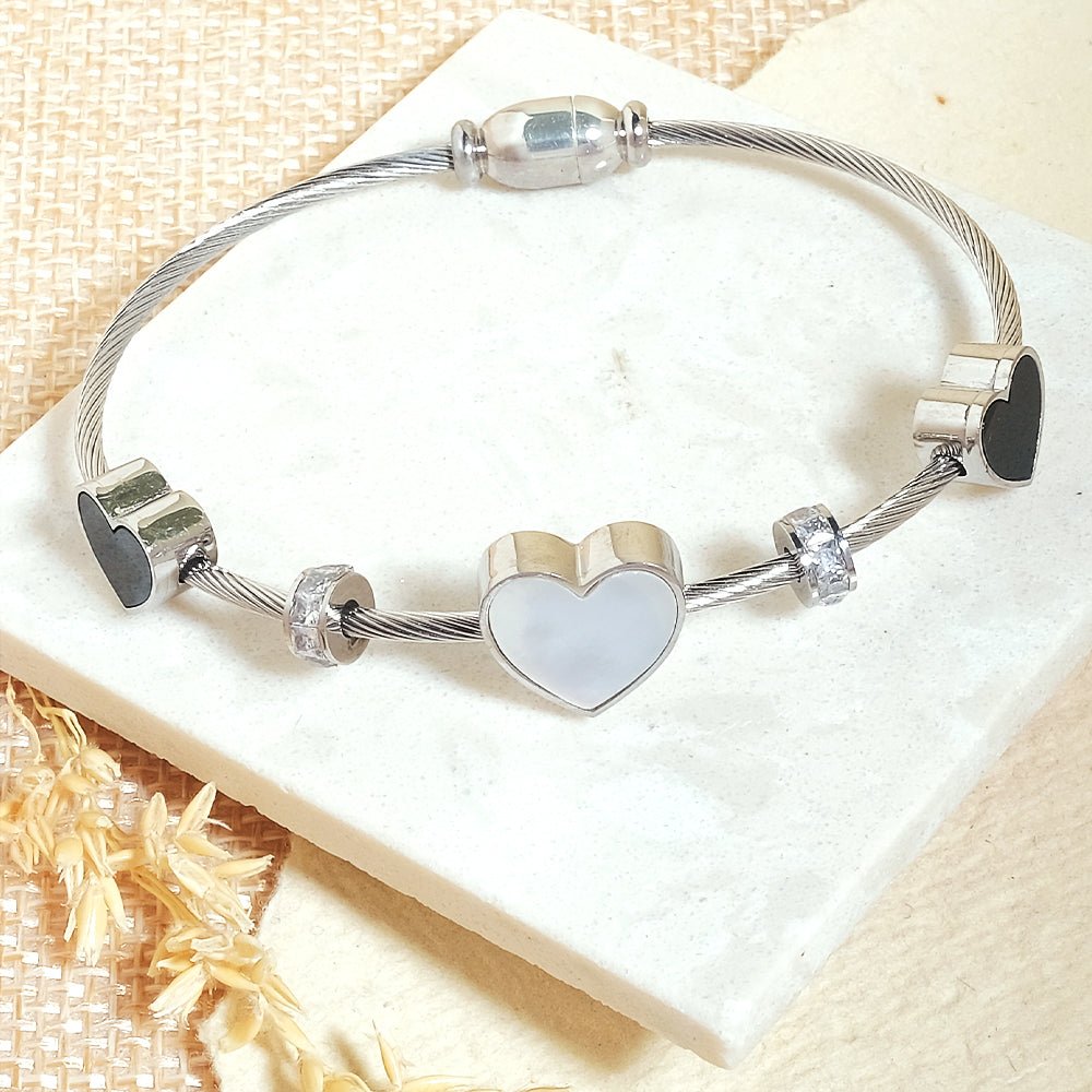 Elegant heart bangle with delicate heart detailing and an anti-tarnish finish, available in golden, silver, and rosegold, perfect for everyday elegance, parties, and thoughtful gifting.
